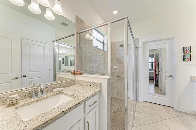 bathroom featuring vanity, an enclosed shower, and tile patterned flooring