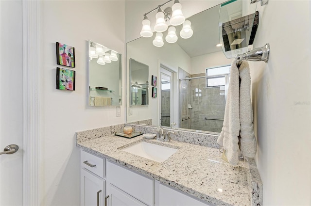 bathroom with vanity and a shower with shower door