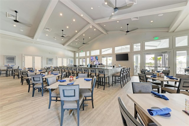 dining area featuring beamed ceiling, light hardwood / wood-style floors, high vaulted ceiling, and french doors