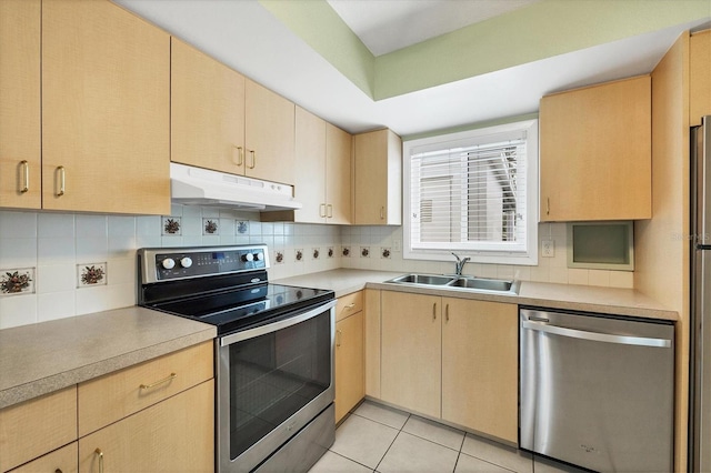 kitchen with tasteful backsplash, appliances with stainless steel finishes, sink, and light brown cabinetry