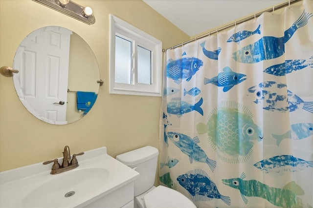 bathroom featuring toilet, vanity, and a shower with shower curtain