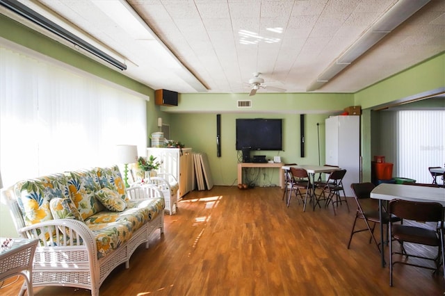 living room with wood-type flooring and ceiling fan