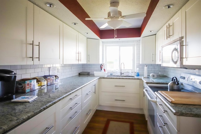 kitchen with sink, white cabinetry, tasteful backsplash, a raised ceiling, and white appliances