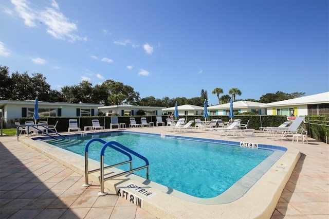 view of swimming pool with a patio