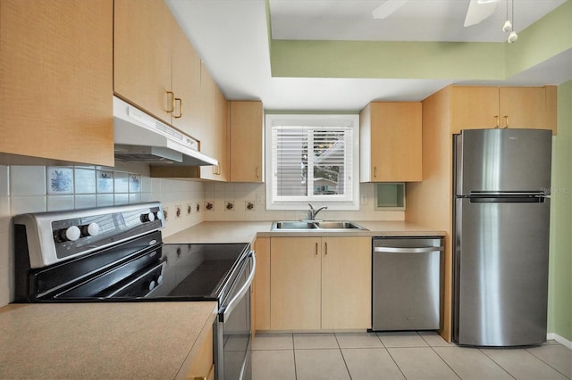 kitchen featuring light tile patterned flooring, light brown cabinetry, sink, tasteful backsplash, and appliances with stainless steel finishes