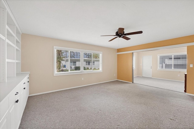 interior space with light carpet and ceiling fan