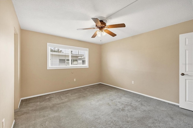 carpeted empty room with ceiling fan and a textured ceiling