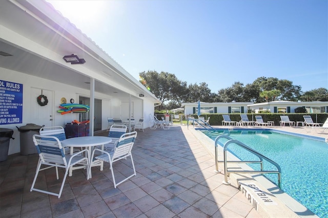 view of swimming pool with a patio