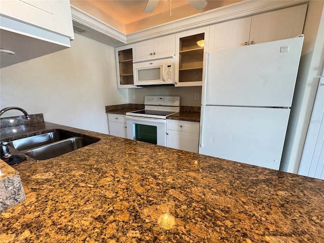 kitchen featuring white appliances, dark stone counters, sink, and white cabinets