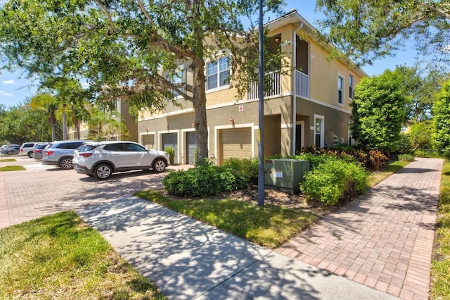 view of front of property with cooling unit and a garage