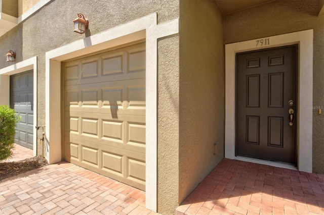 doorway to property with a garage