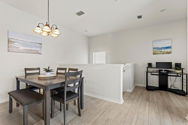 dining space with a chandelier and light wood-type flooring