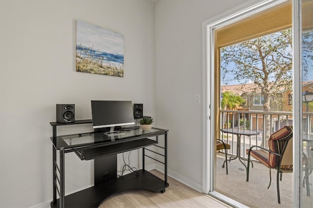 office area with a wealth of natural light and light hardwood / wood-style floors