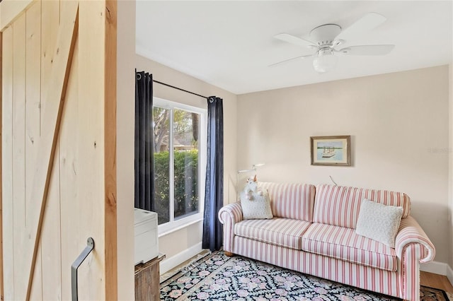 living room featuring light wood-type flooring and ceiling fan