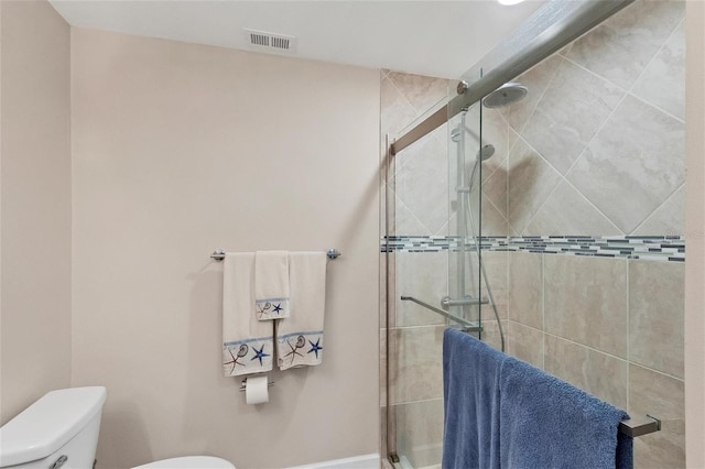 bathroom featuring toilet and an enclosed shower