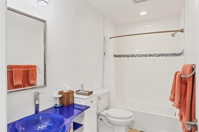 full bathroom featuring tiled shower / bath combo, sink, and toilet