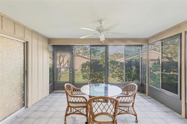 sunroom / solarium featuring ceiling fan