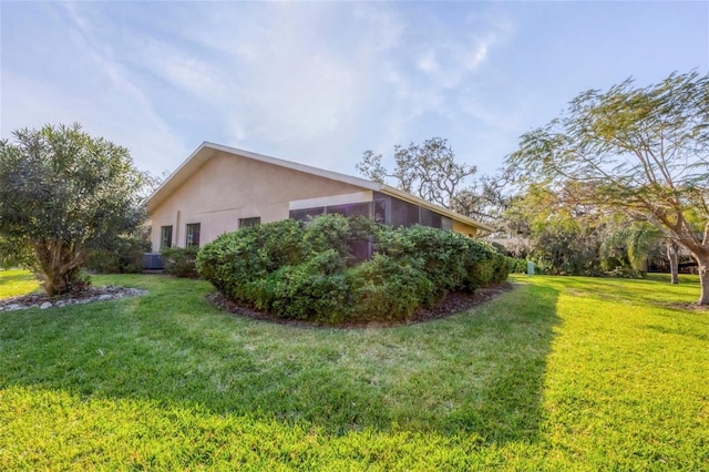 view of side of home with a lawn