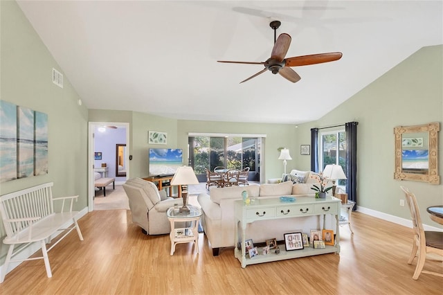 living room featuring light hardwood / wood-style floors, high vaulted ceiling, and ceiling fan