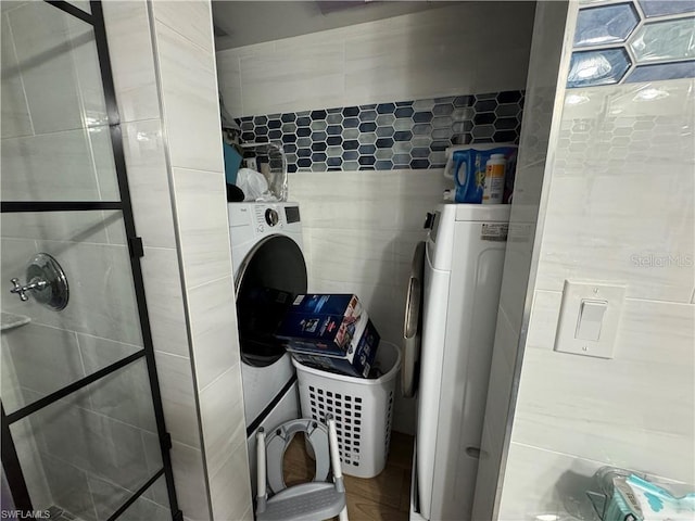 washroom featuring washer / clothes dryer and tile walls