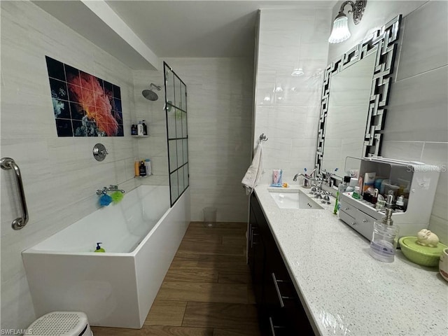 bathroom with vanity, tile walls, and a tile shower