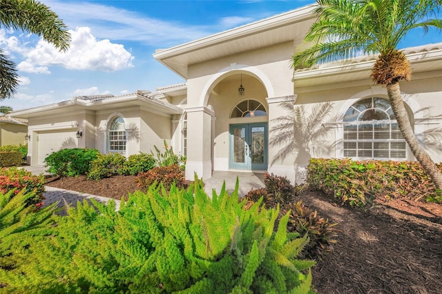 entrance to property with french doors and a garage