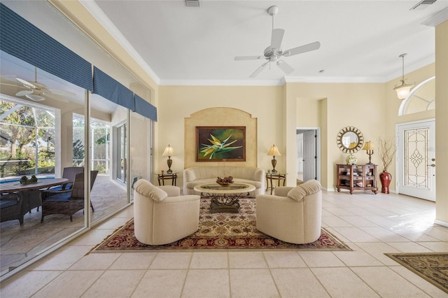 tiled living room featuring crown molding, ceiling fan, and a high ceiling