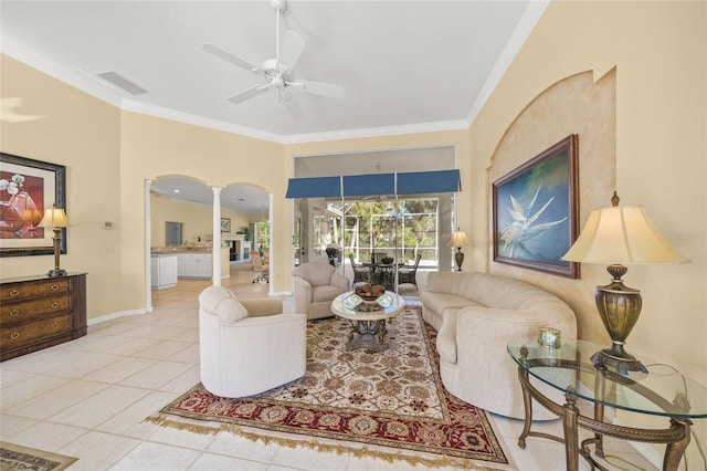 tiled living room with ornamental molding, ceiling fan, and ornate columns