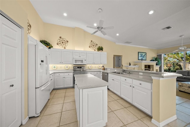 kitchen with a kitchen island, white cabinetry, ceiling fan, kitchen peninsula, and white appliances