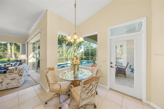 tiled dining area featuring an inviting chandelier, crown molding, and vaulted ceiling