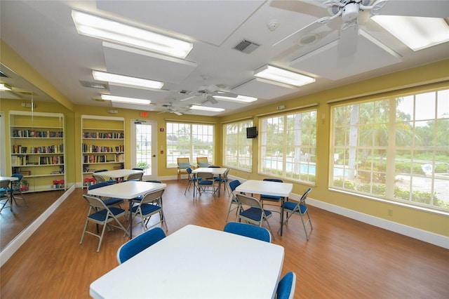 dining area with hardwood / wood-style floors and ceiling fan