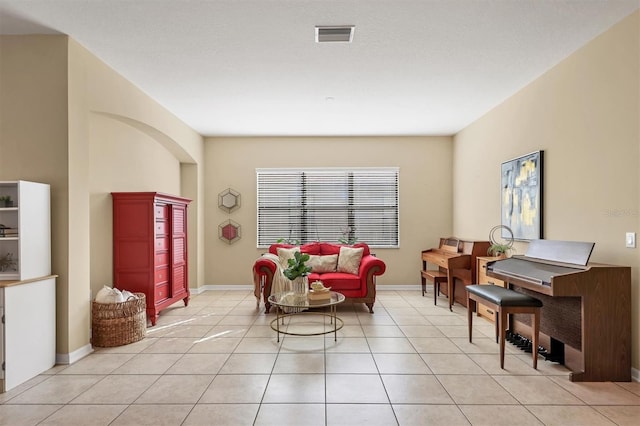 sitting room with light tile patterned floors, visible vents, and baseboards