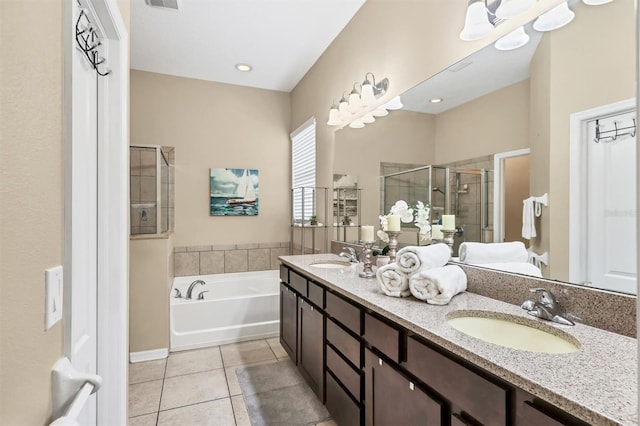 bathroom featuring double vanity, a stall shower, a bath, tile patterned floors, and a sink