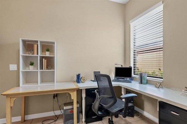 office area with light tile patterned flooring and baseboards