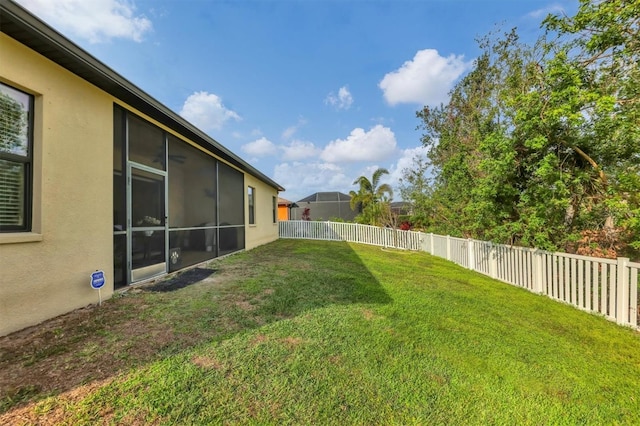 view of yard with a fenced backyard and a sunroom