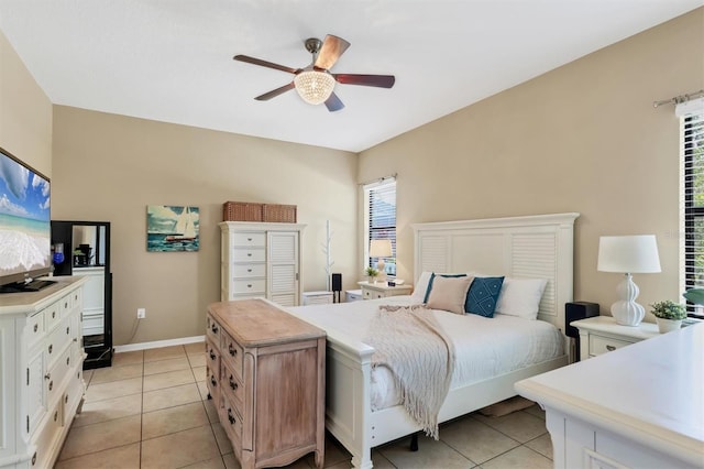 bedroom featuring light tile patterned flooring, baseboards, and ceiling fan