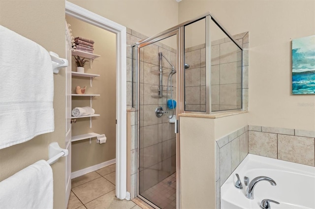 full bath featuring tile patterned floors, a stall shower, and a bath