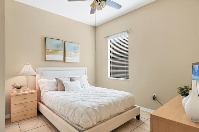 bedroom featuring light tile patterned floors, ceiling fan, and baseboards