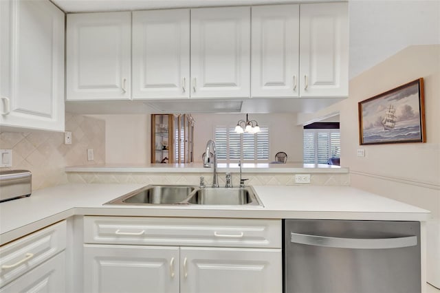 kitchen featuring white cabinetry, sink, stainless steel dishwasher, and backsplash