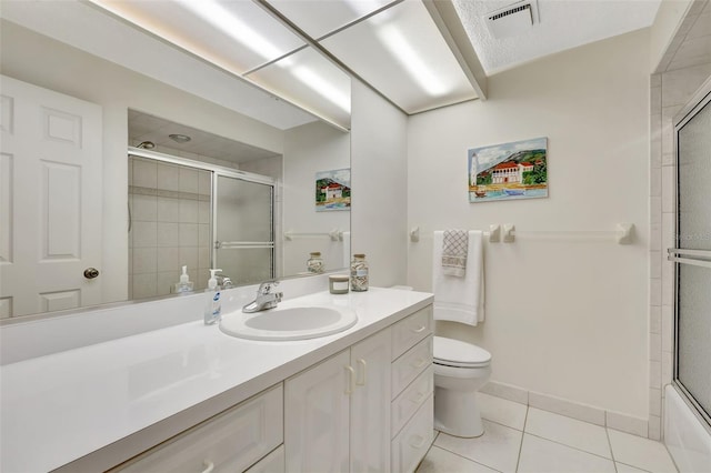 full bathroom with tile patterned flooring, vanity, enclosed tub / shower combo, and toilet