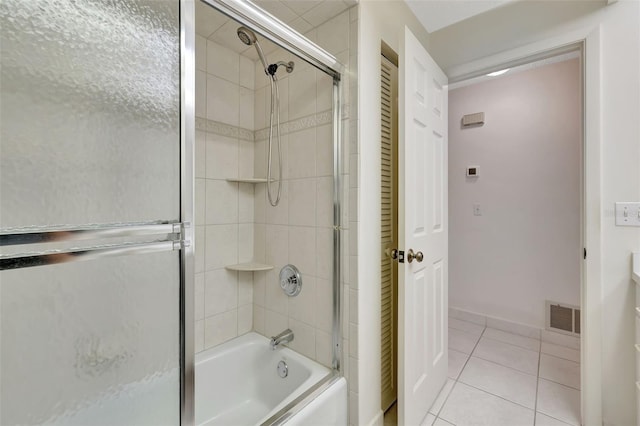 bathroom with tile patterned floors and bath / shower combo with glass door