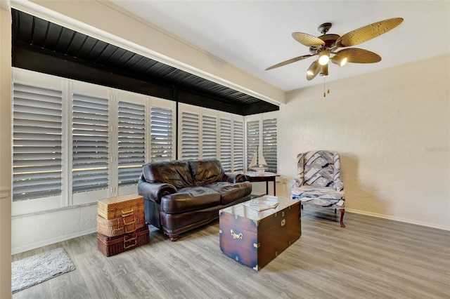 living room featuring wood-type flooring and ceiling fan