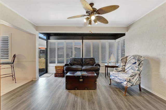 living room featuring crown molding, ceiling fan, and hardwood / wood-style floors