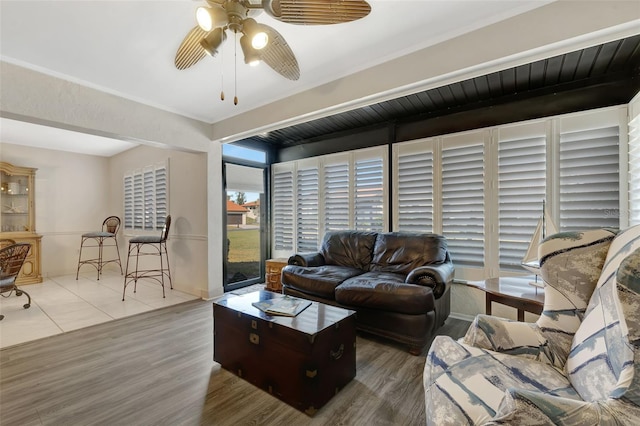 living room featuring ceiling fan and wood-type flooring