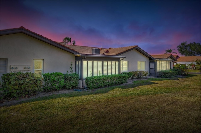 exterior space featuring cooling unit and a lawn