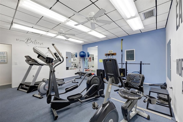 gym featuring a paneled ceiling and ceiling fan