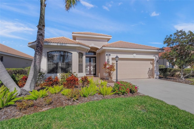 mediterranean / spanish-style home featuring a garage and french doors