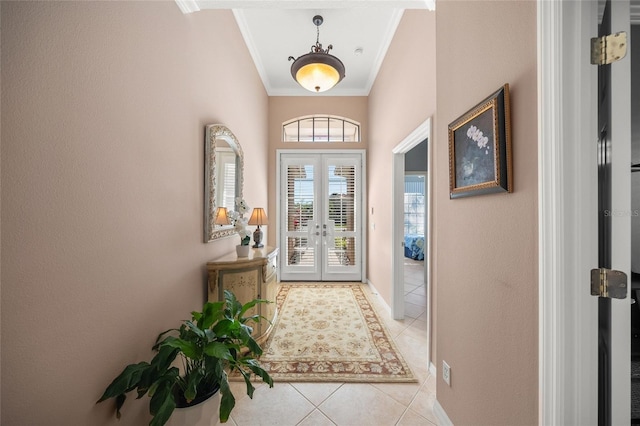 entryway featuring french doors, ornamental molding, and light tile patterned floors