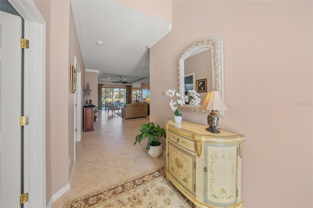 corridor with ornamental molding and light tile patterned floors