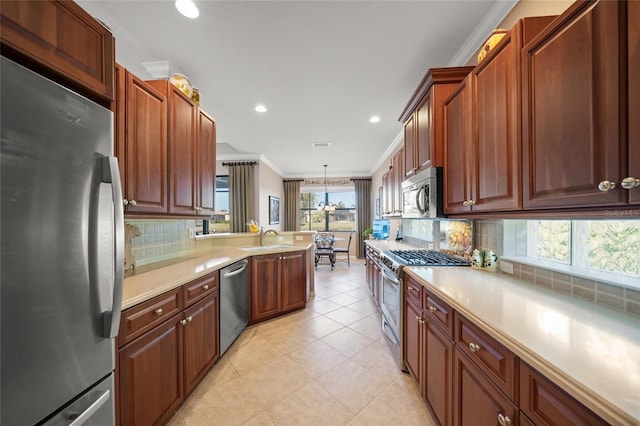 kitchen with appliances with stainless steel finishes, pendant lighting, decorative backsplash, ornamental molding, and light tile patterned floors